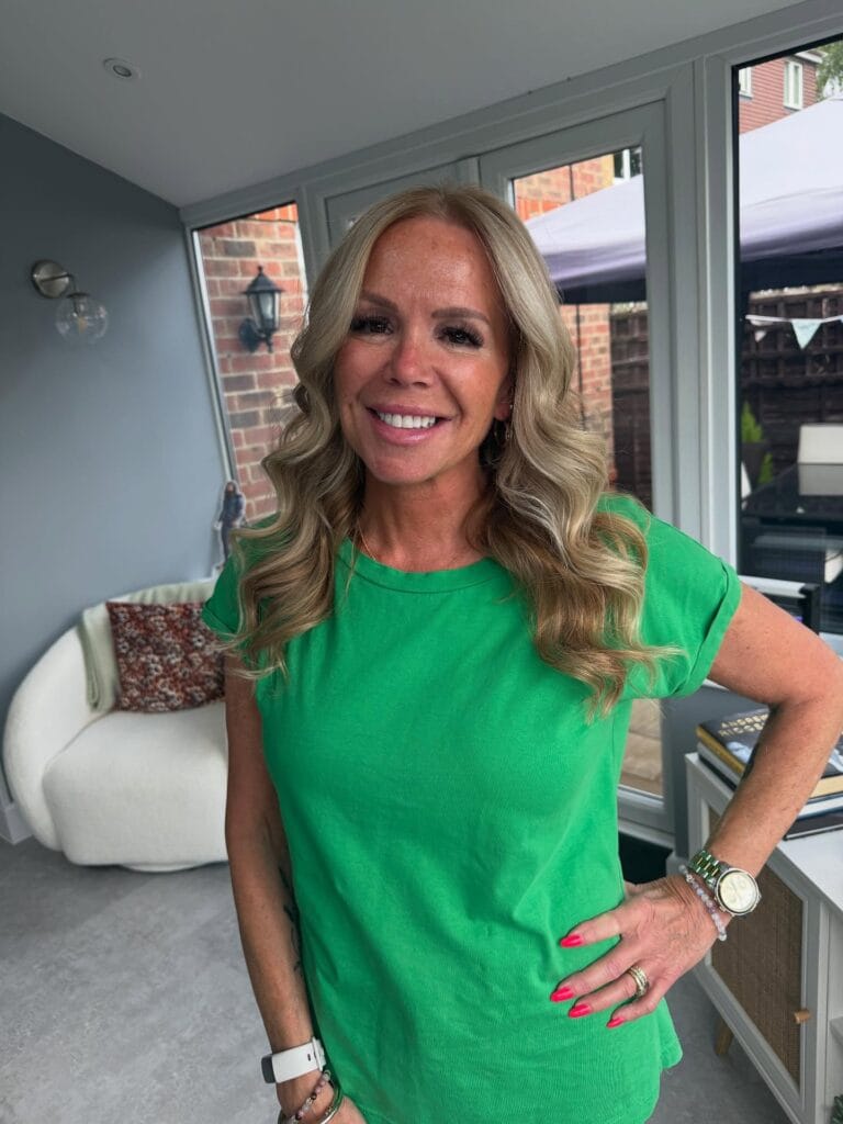 Long layered honey blonde hair with soft flowing waves.