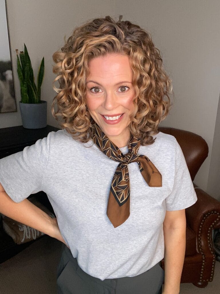 Shoulder length curly hairstyle with defined golden curls and layered volume.