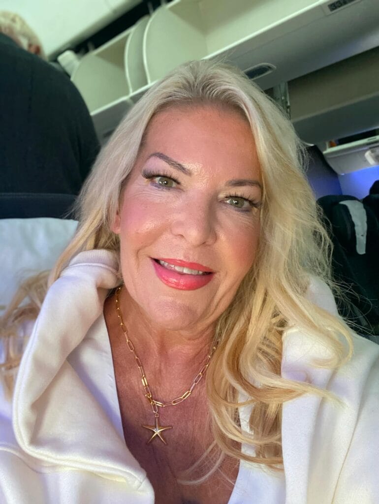 Long platinum blonde hair styled with voluminous soft waves.