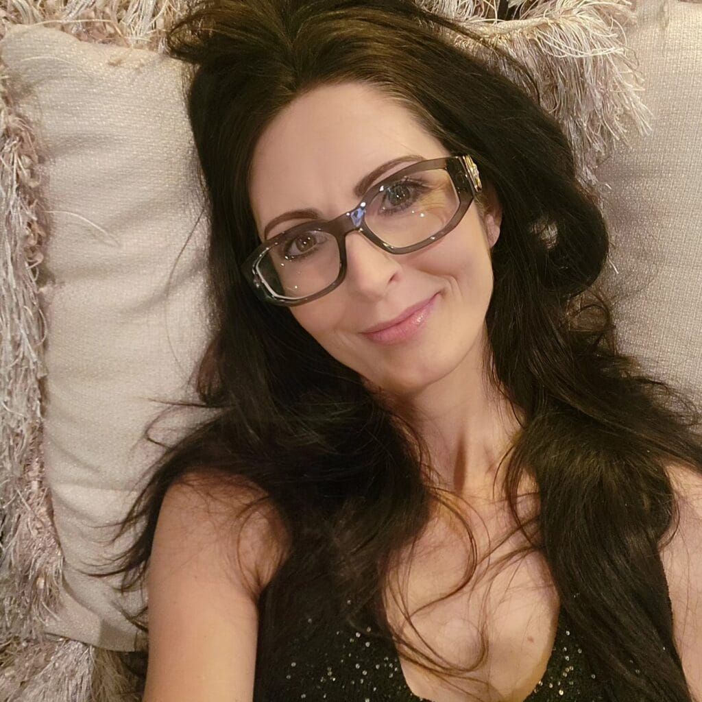 Long dark brunette hair with soft layers and loose flowing waves.