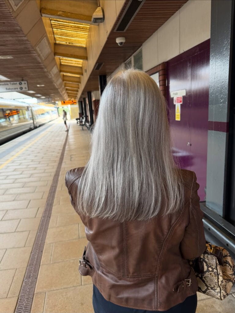 Long silver gray hair worn loose with soft natural texture.