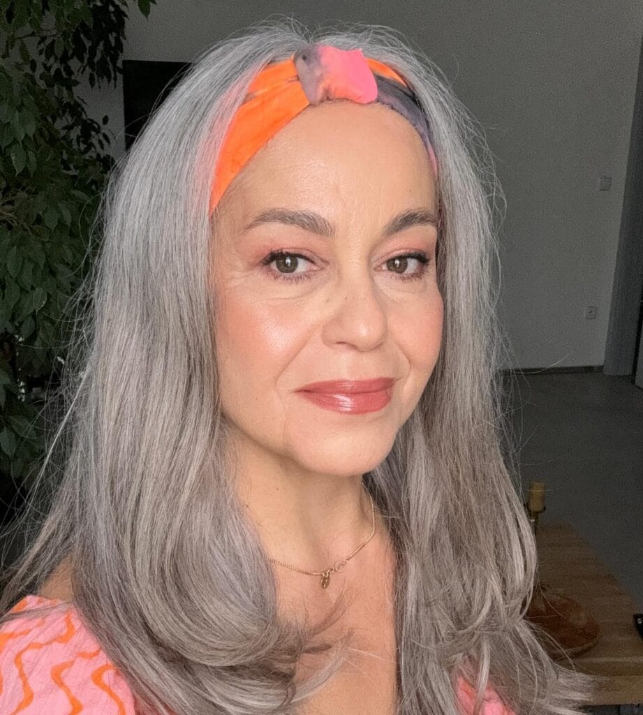 Long gray hair with feathered layers and soft movement.