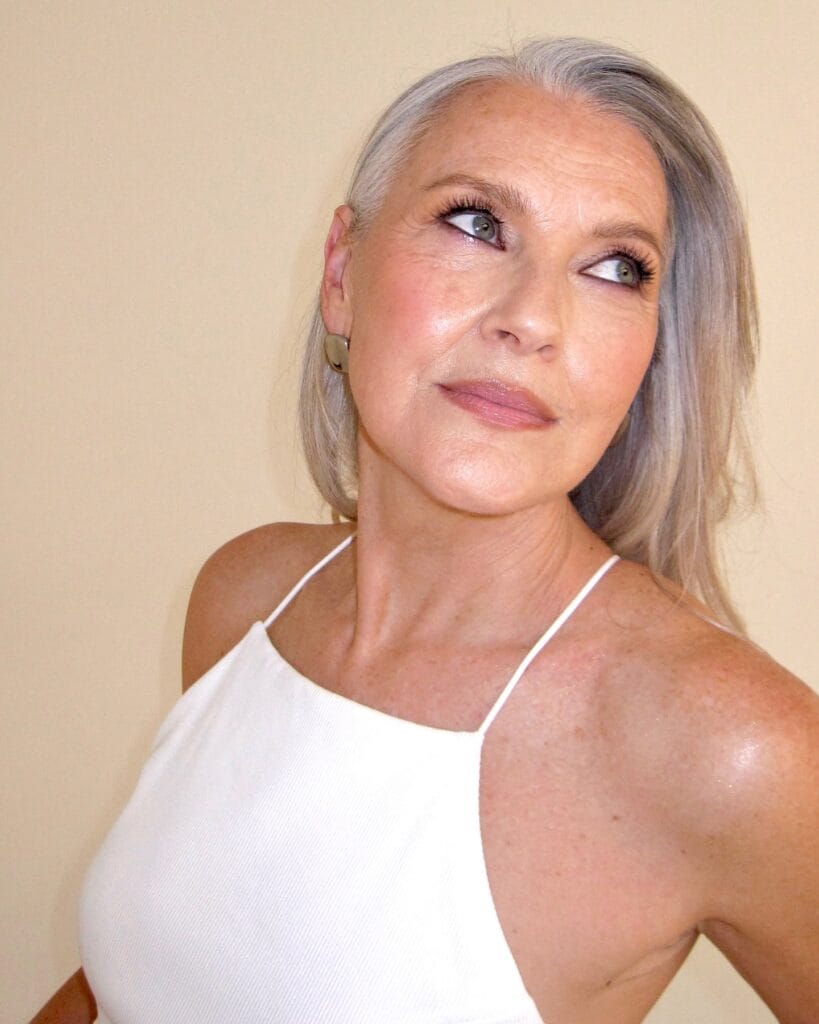 Long gray hair with darker natural roots and soft texture.