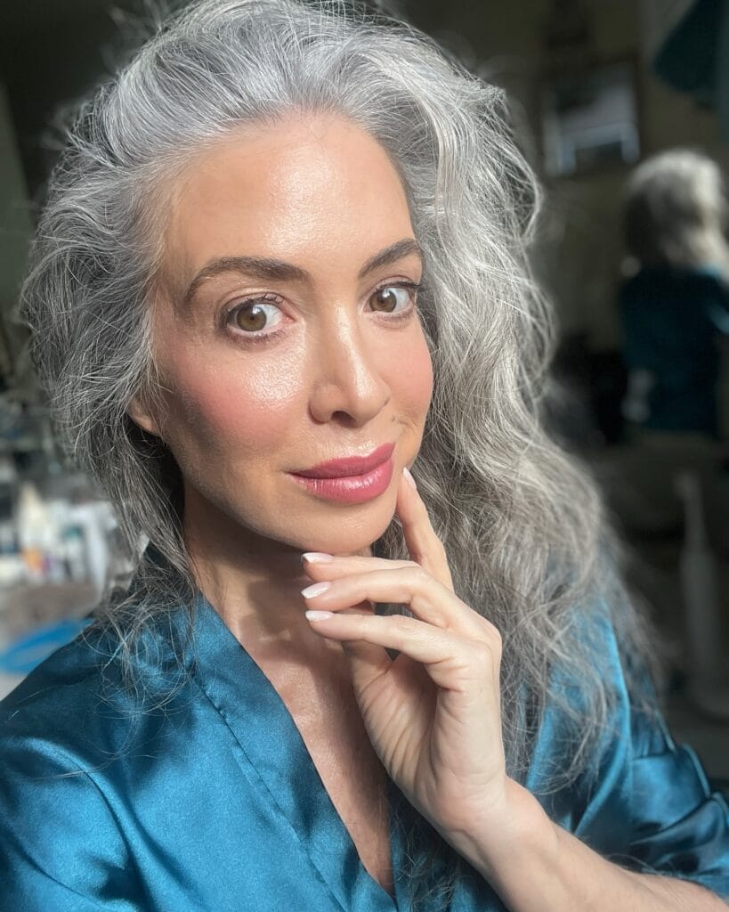 Long smooth silver gray hair worn loose over the shoulders.