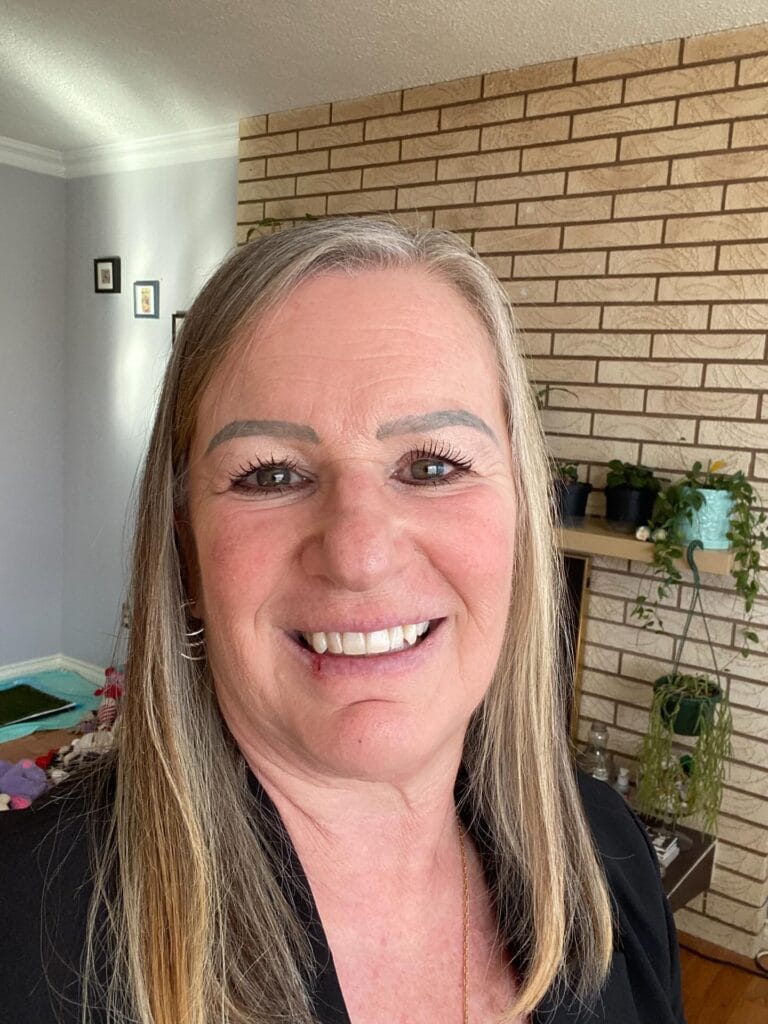 Mid length straight hairstyle with subtle highlights and a smooth polished finish.