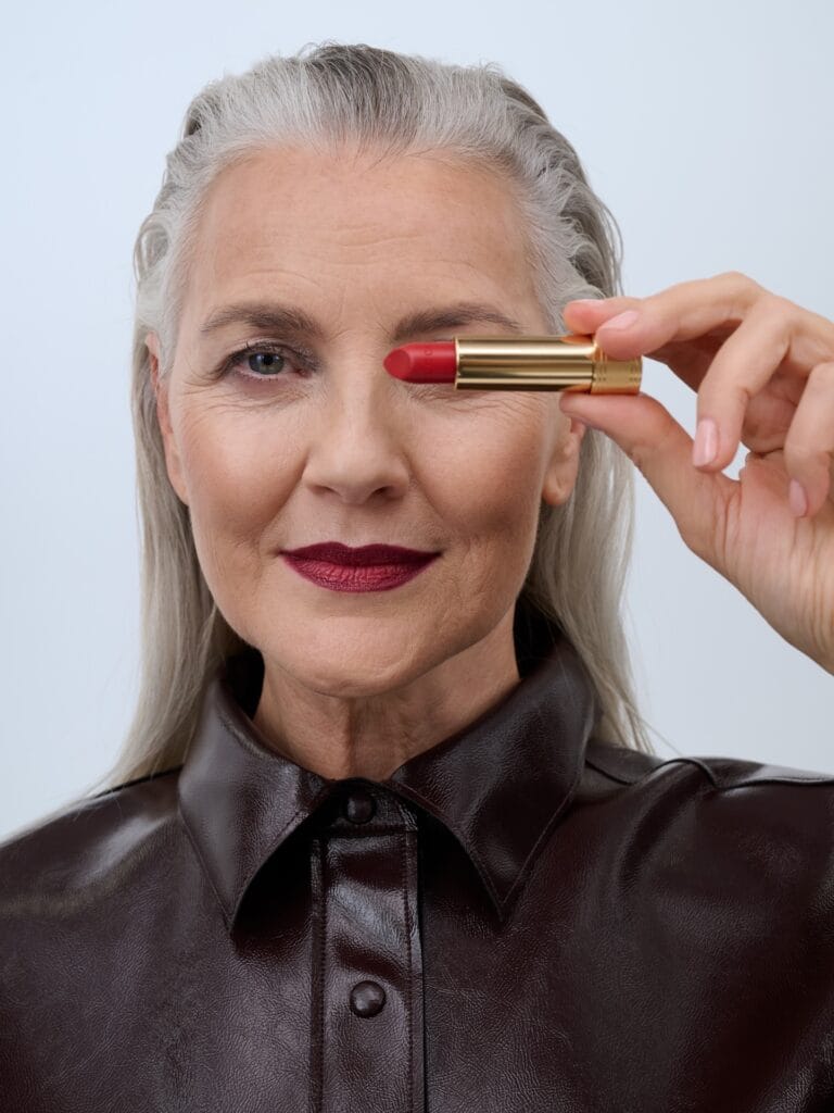 Long silver hairstyle with volume at the crown and smooth brushed back length.