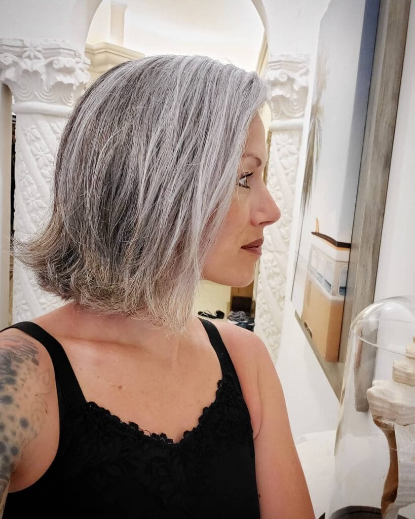Wavy gray bob with soft layers and natural textured finish at jaw length.