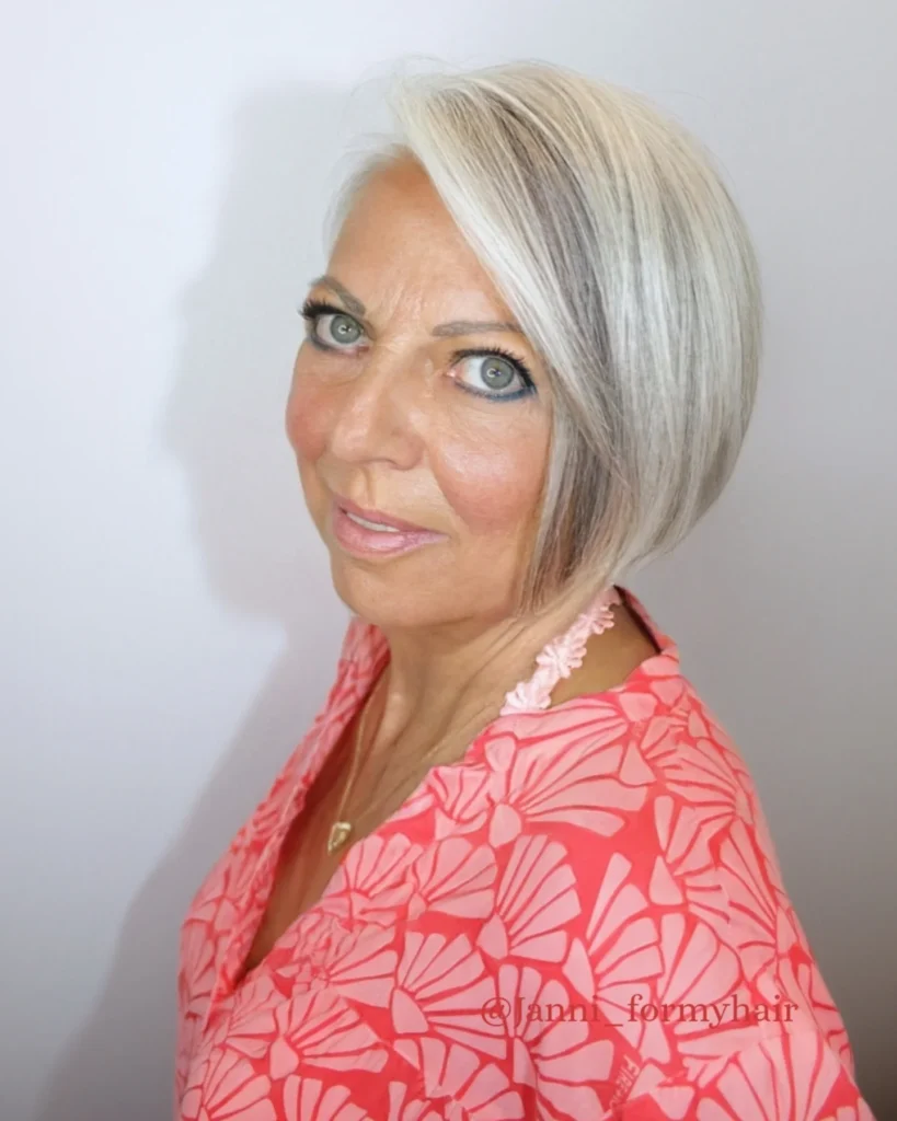 Angled gray bob with shorter back and longer side swept front layers.