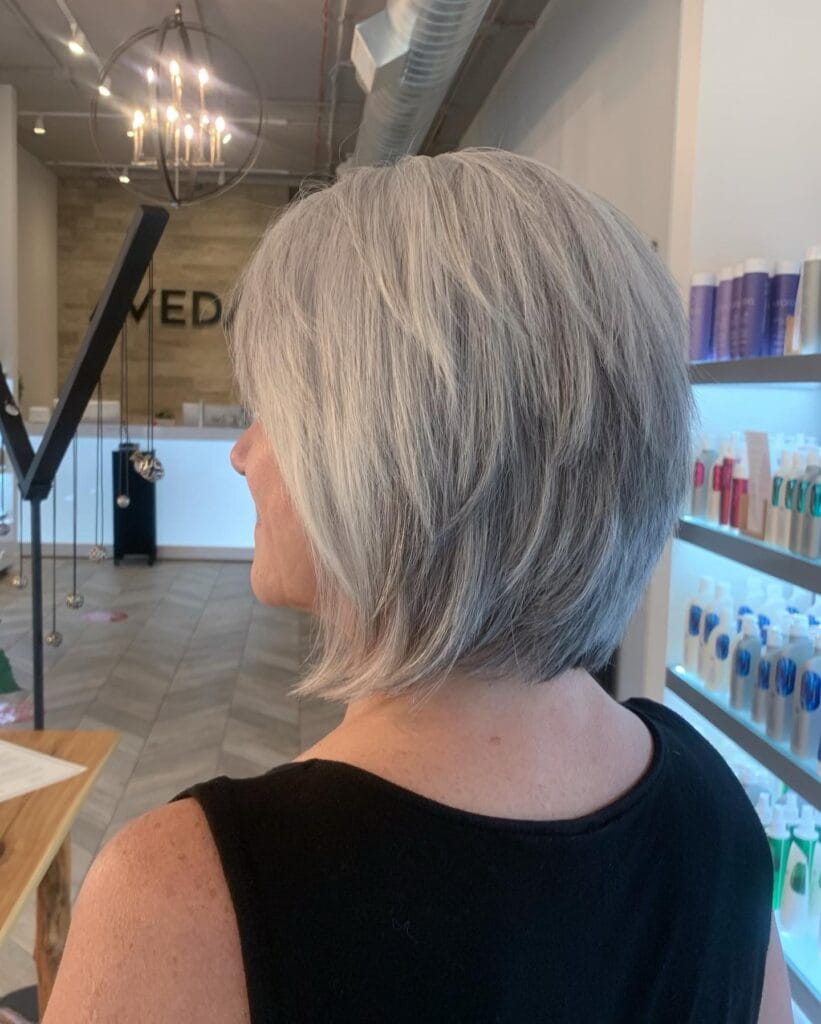 Layered gray bob with soft volume and slightly longer back creating a rounded shape.