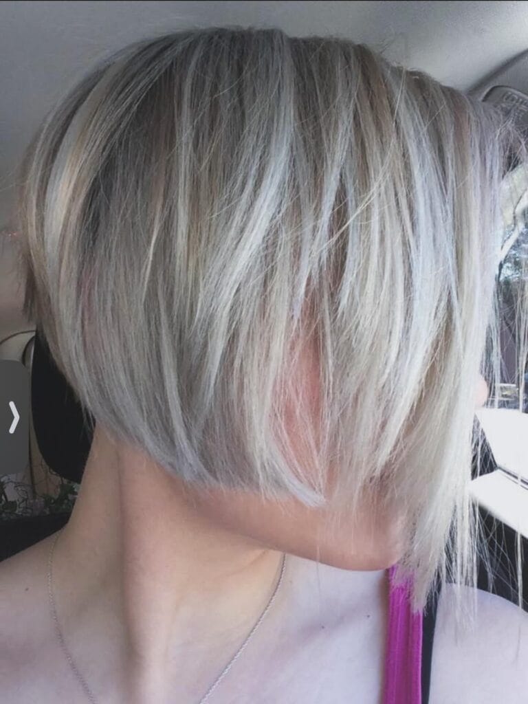 Angled silver gray bob with longer front layers and shorter back creating a modern shape.