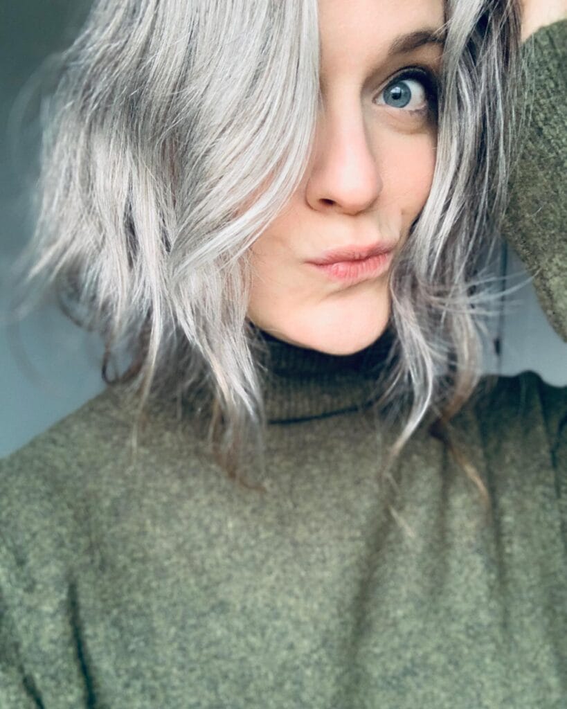 Wavy gray bob with a side part and soft tousled texture falling just above the shoulders.