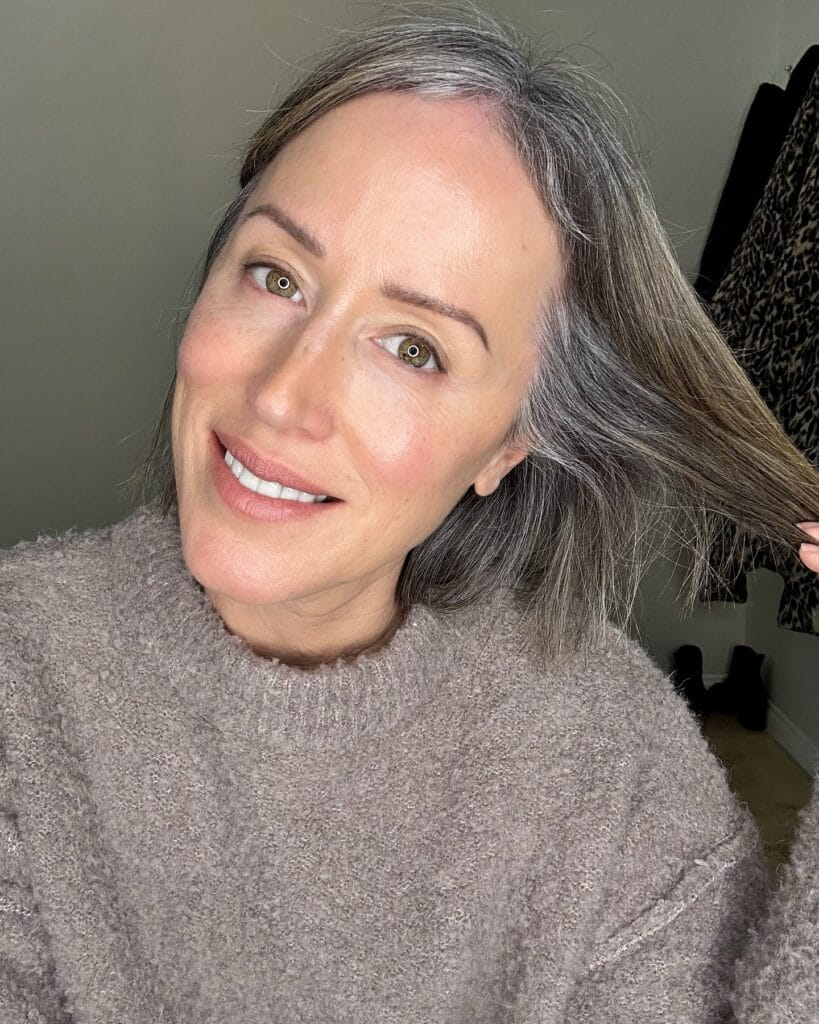 Natural gray bob with middle part and soft texture sitting around the jawline.