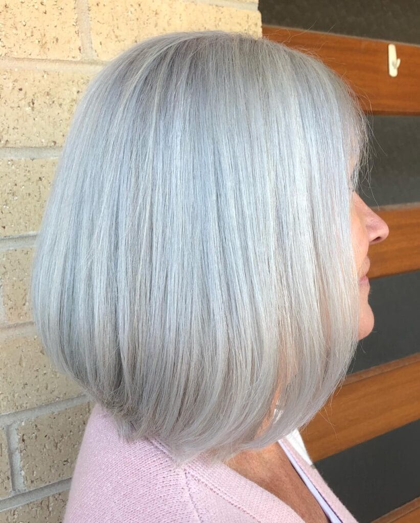 Chin length sleek silver gray blunt bob with smooth straight texture and softly curved ends.