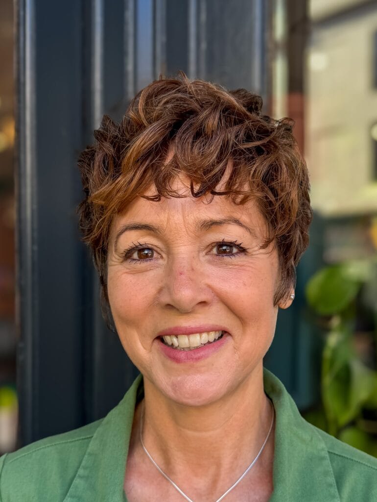 Short curly crop with defined texture and soft layered shape.