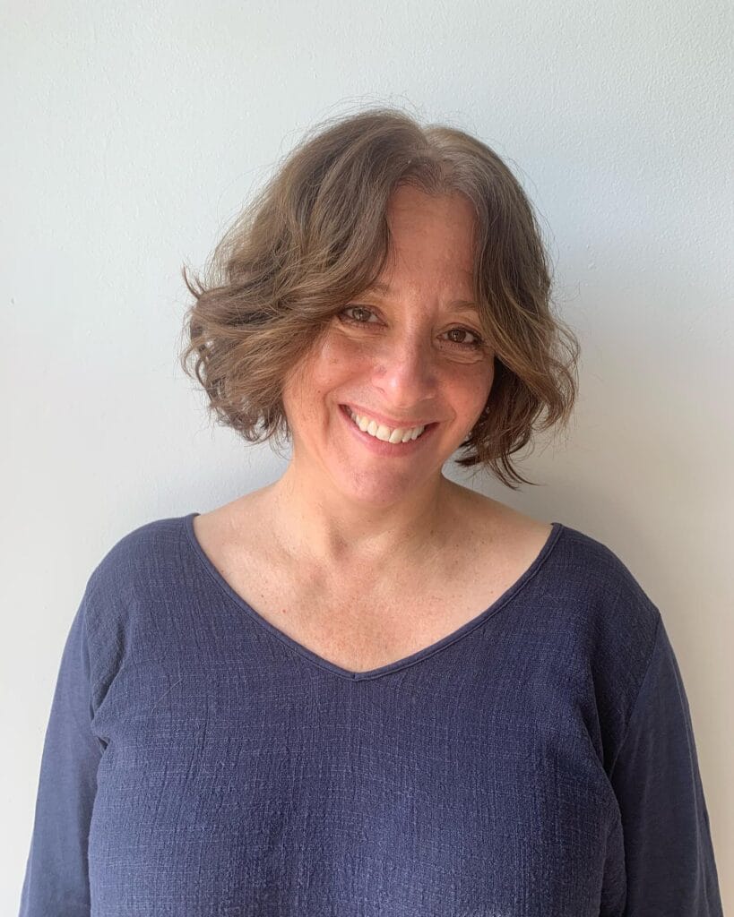 Chin length brown wavy bob with soft natural waves and light texture.