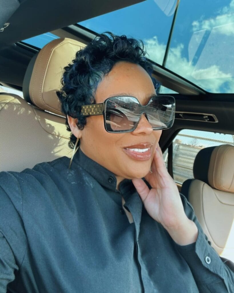 Short dark wavy curly cropped hairstyle with natural texture and volume.