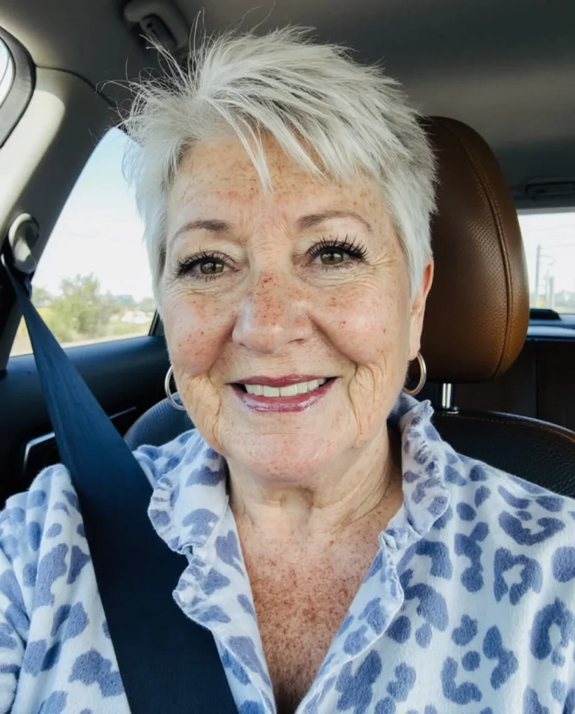 Short silver wavy pixie haircut with soft choppy layers and light volume.