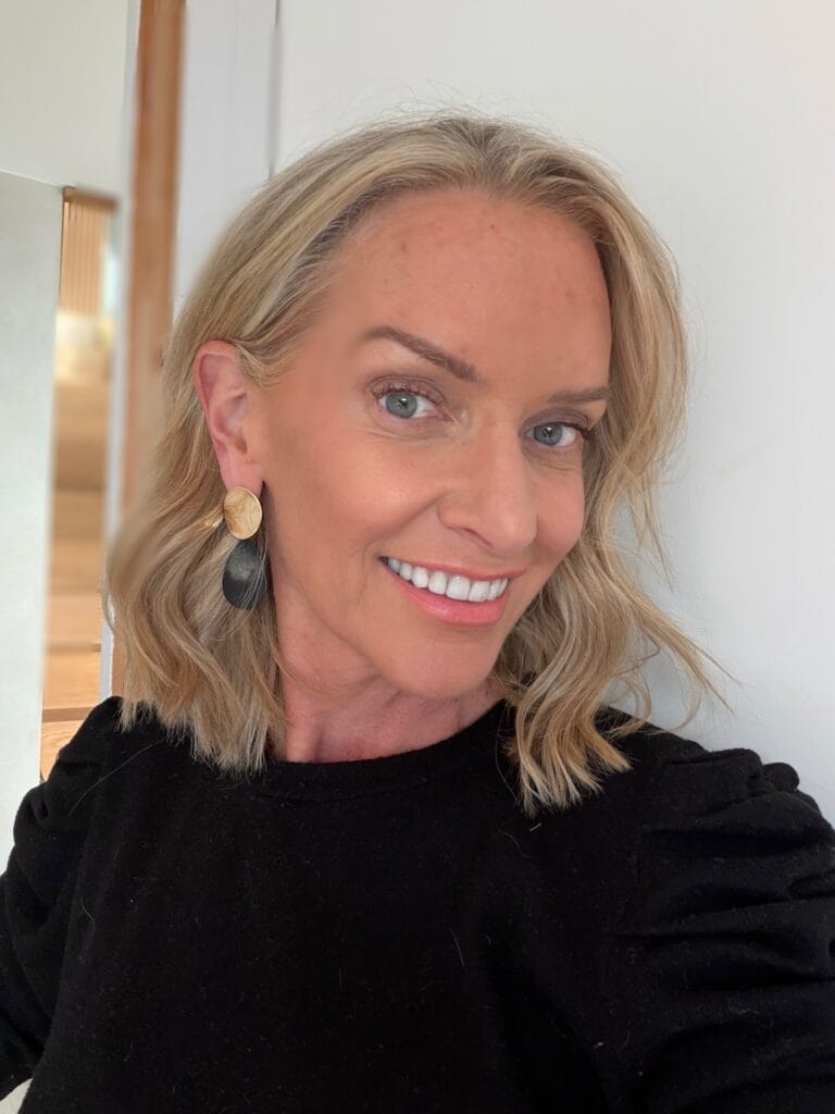 Short blonde wavy lob with soft layers and natural movement.