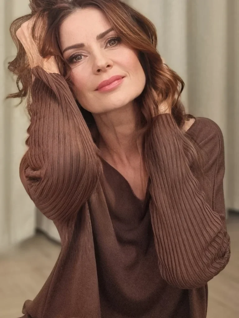 Shoulder length brunette hair styled with soft loose waves.