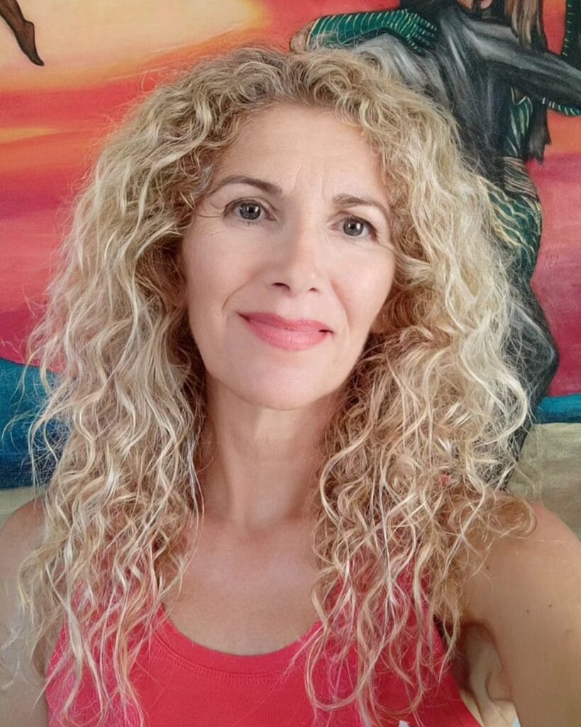 Long layered curly hairstyle with natural volume and soft texture.