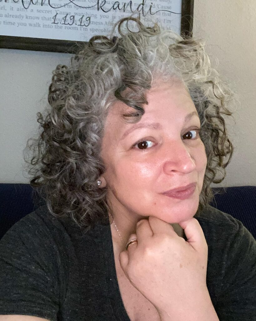 Short gray curly hairstyle with natural texture and rounded shape