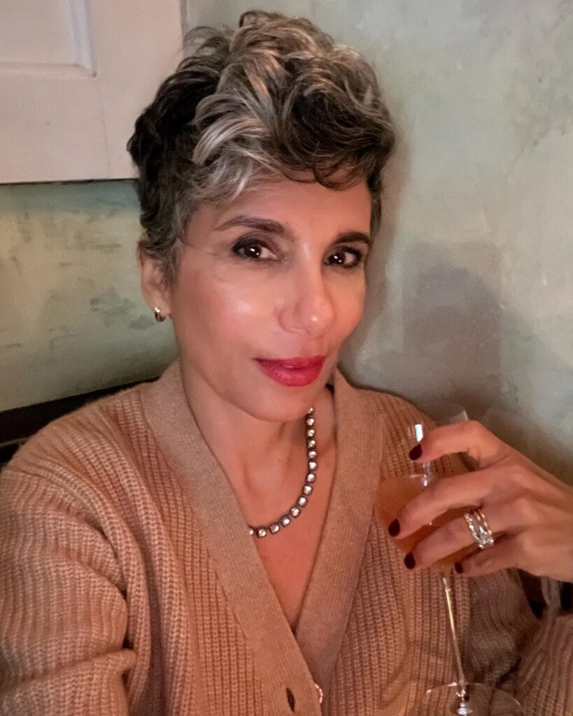 Brunette pixie haircut with voluminous textured crown and short sides.