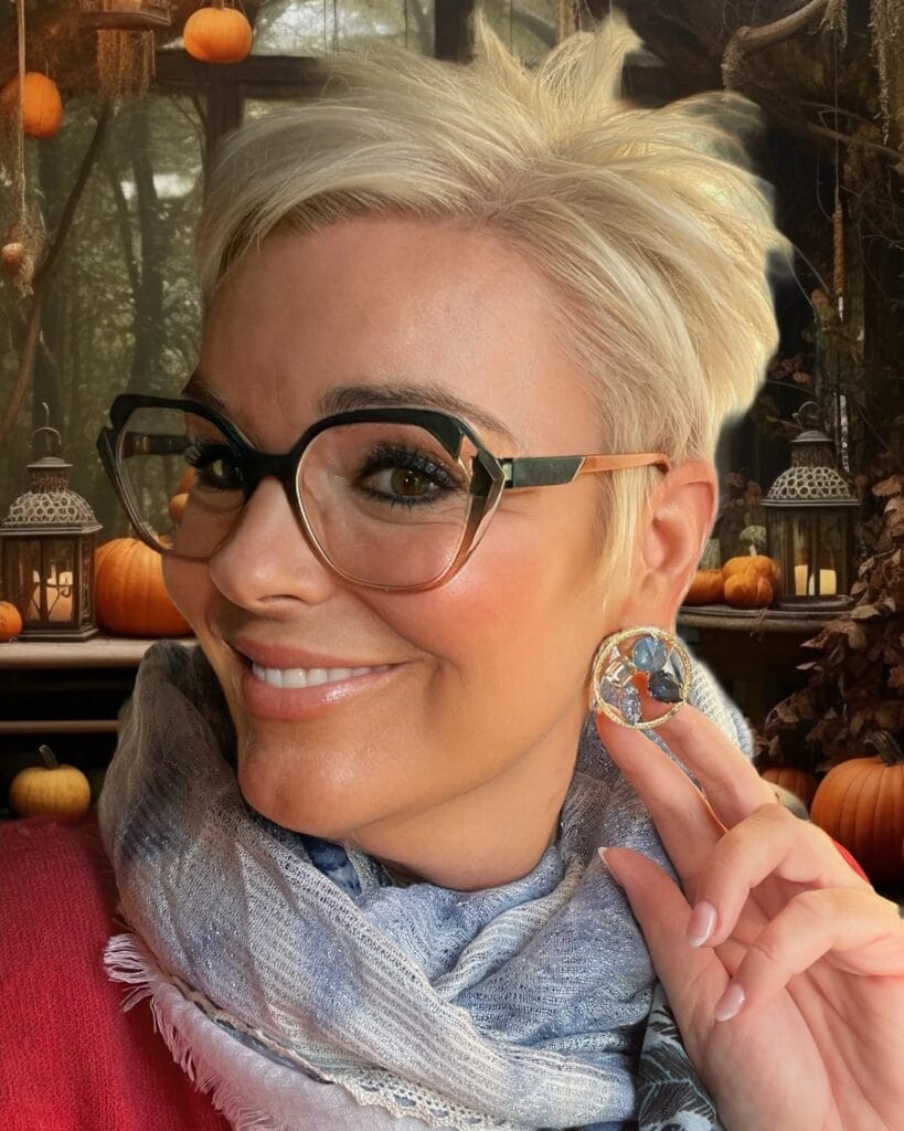 Short blonde spiky pixie haircut with textured layers and cropped sides.