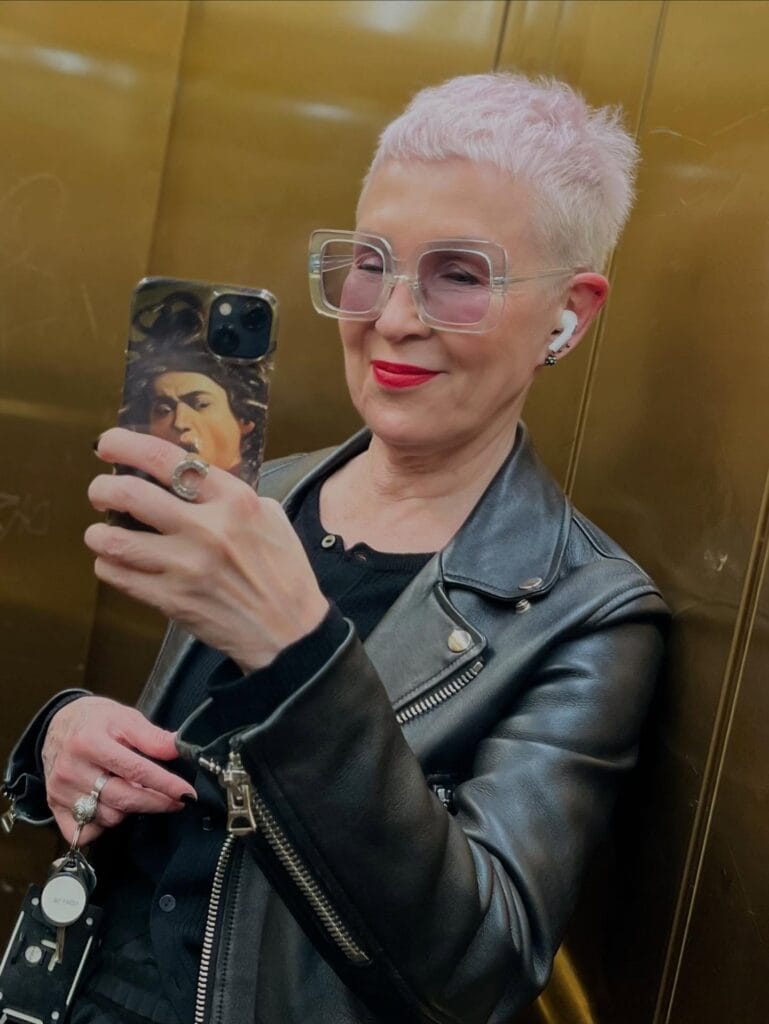 Ultra short platinum buzz pixie haircut with cropped sides and light textured top.