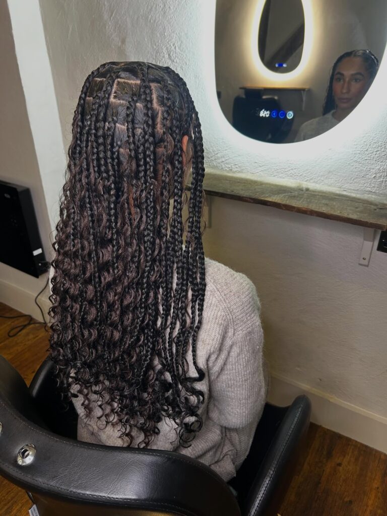 Dark chocolate goddess braids with curly strands and neat square braid sections.