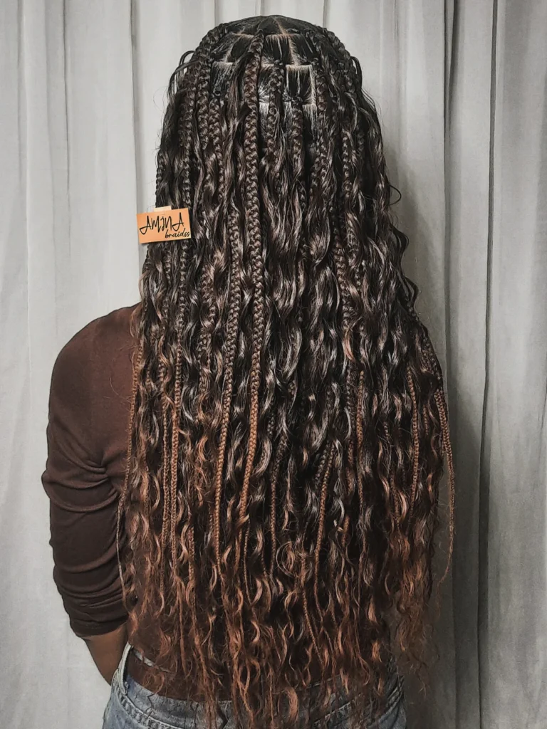Long mocha brown goddess braids with loose wavy strands and subtle lighter highlights.
