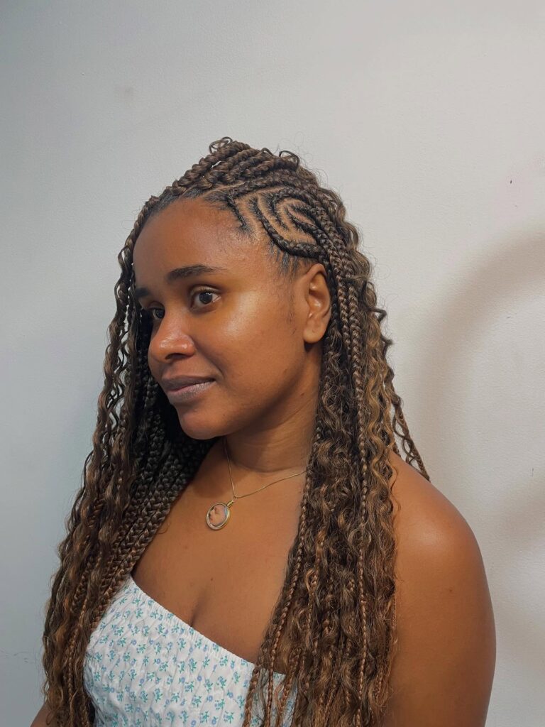 Ash brown goddess braids with a side part and soft crimped wavy texture.
