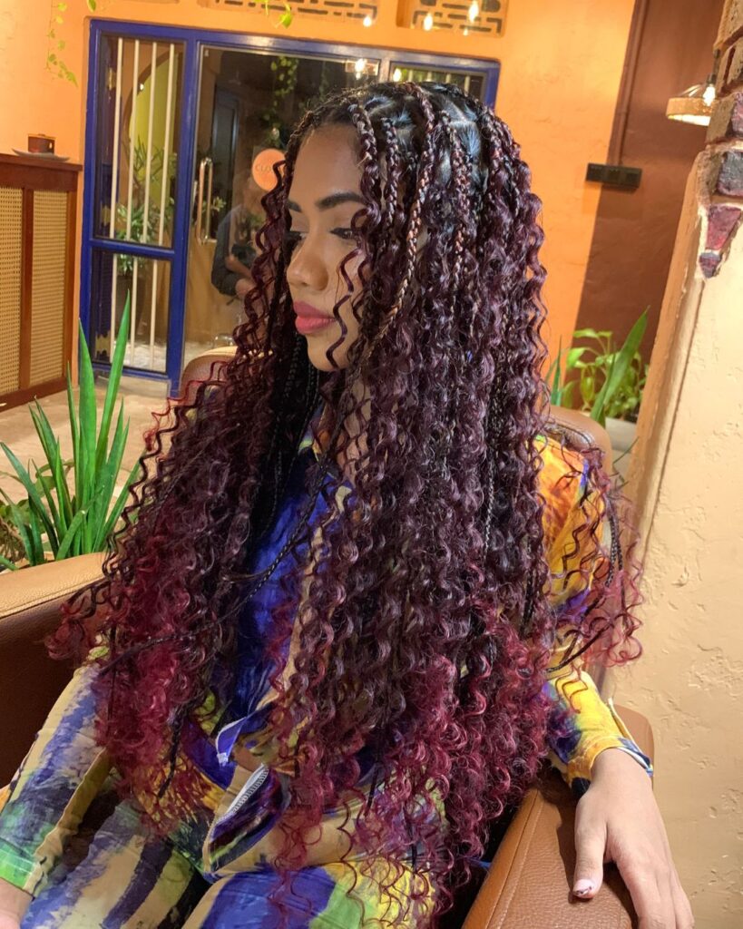Long plum ombre goddess braids with dark burgundy roots and curly wine colored ends.