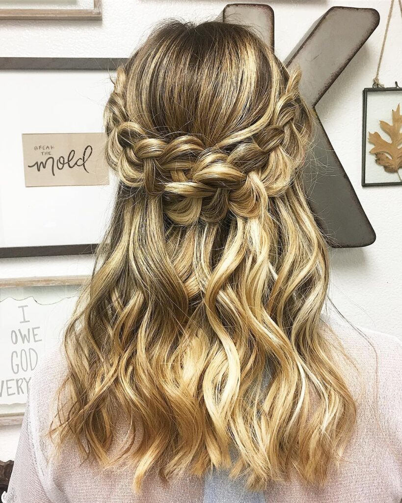 A blonde wavy lob with chunky Dutch braids styled into a half up crown braid.