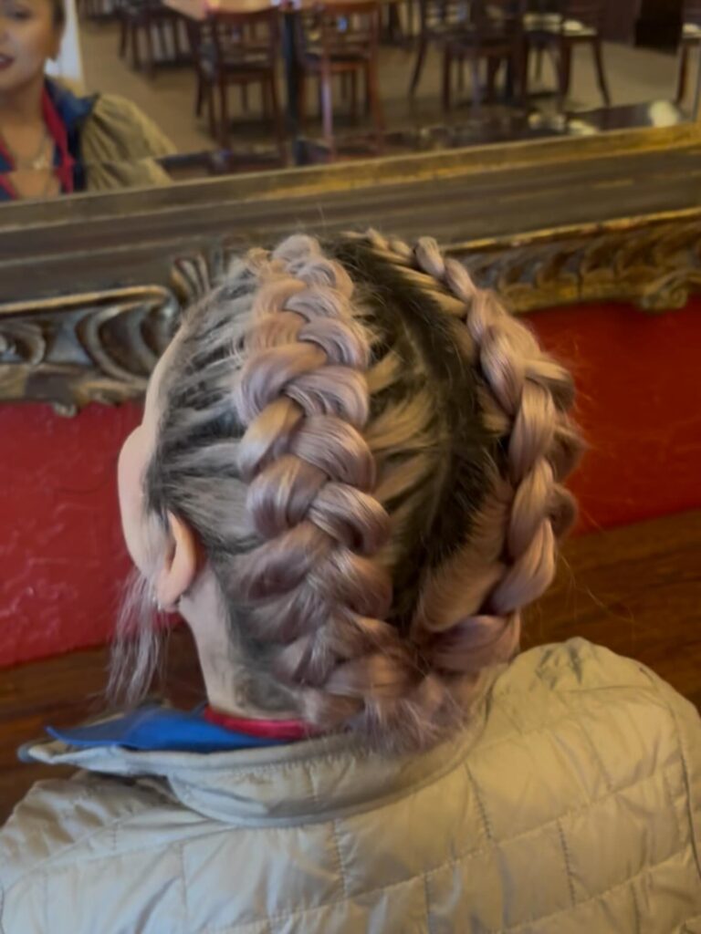 Chunky lavender Dutch braids with dark roots styled in two thick braided sections.