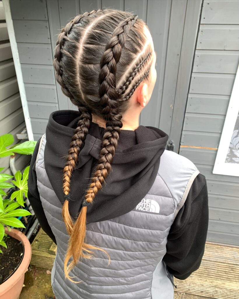 Dark brunette Dutch braids with smaller accent braids and lighter brown ends.