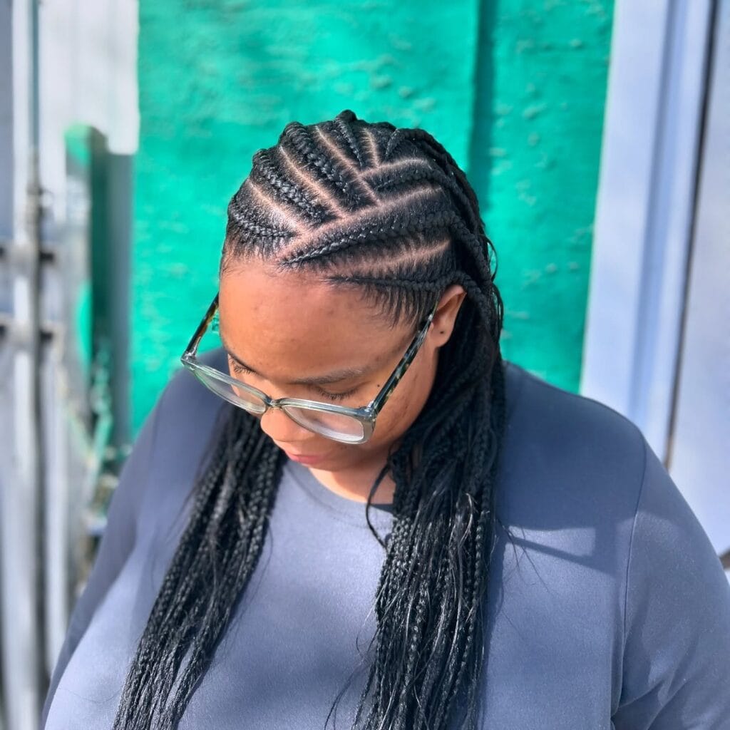 Front cornrows flowing into long loose box braids with a sleek scalp pattern.