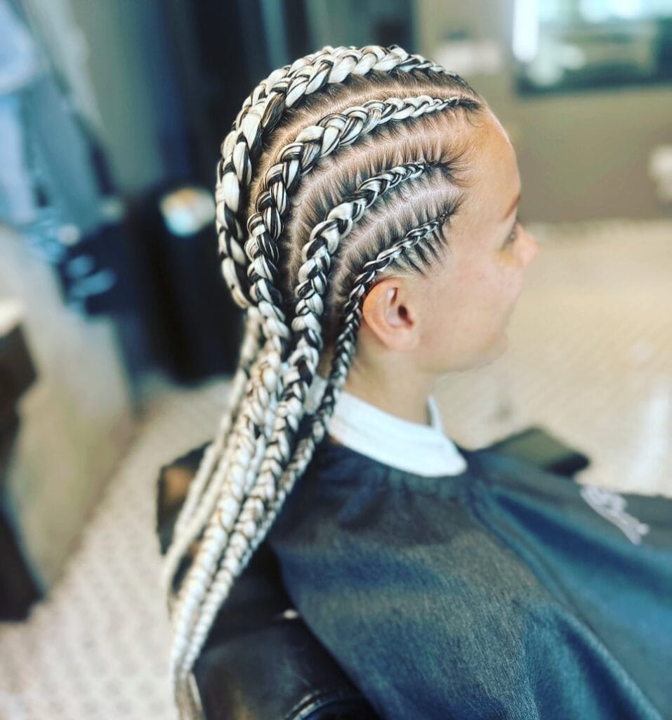 Cornrow braids with blonde highlights braided through darker hair.