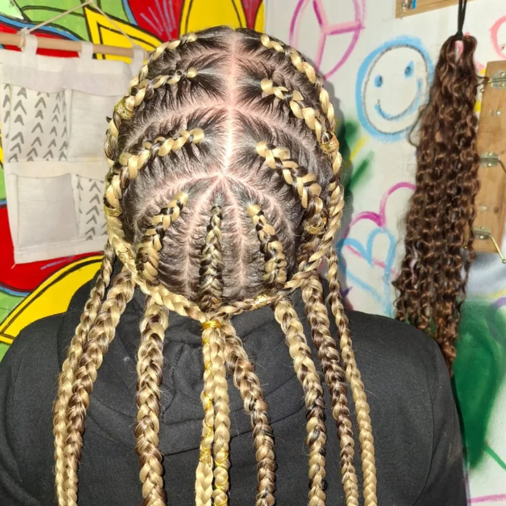 Cornrows braided in a radiating pattern flowing into long braids.
