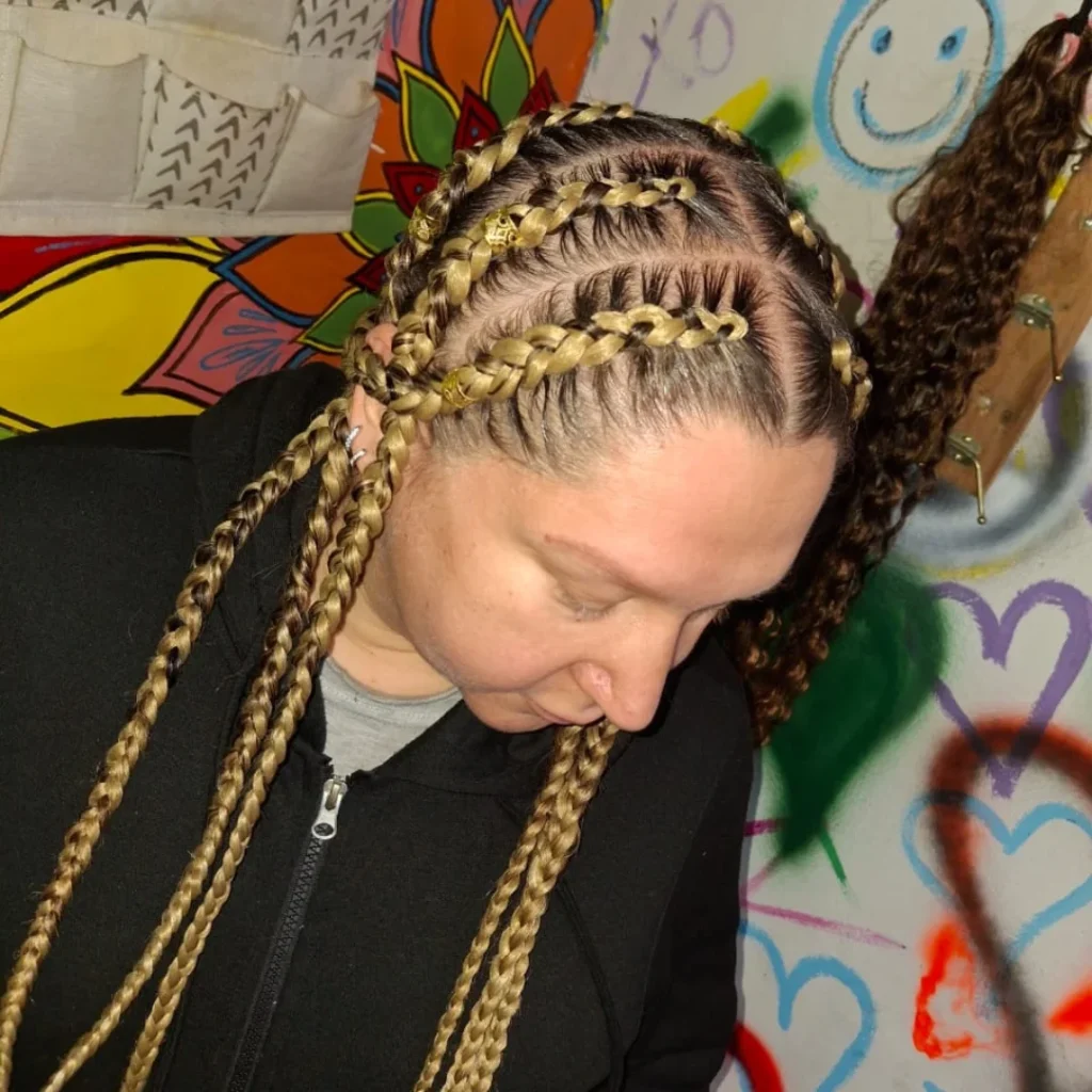 Cornrow braids styled with long blonde braided extensions.