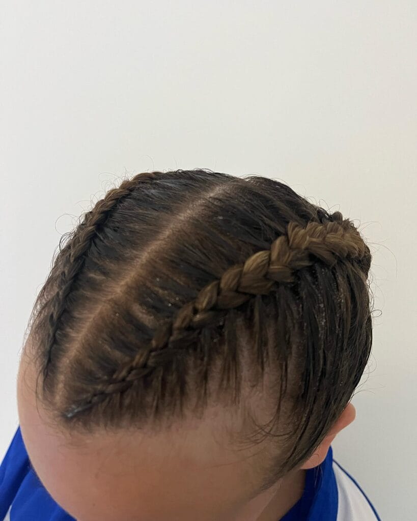 Side braid along the scalp leading into a braided ponytail.