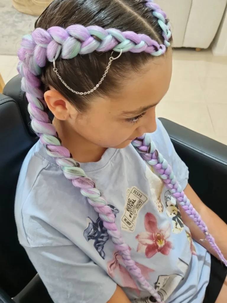 Two long braided pigtails with soft purple pastel extensions.