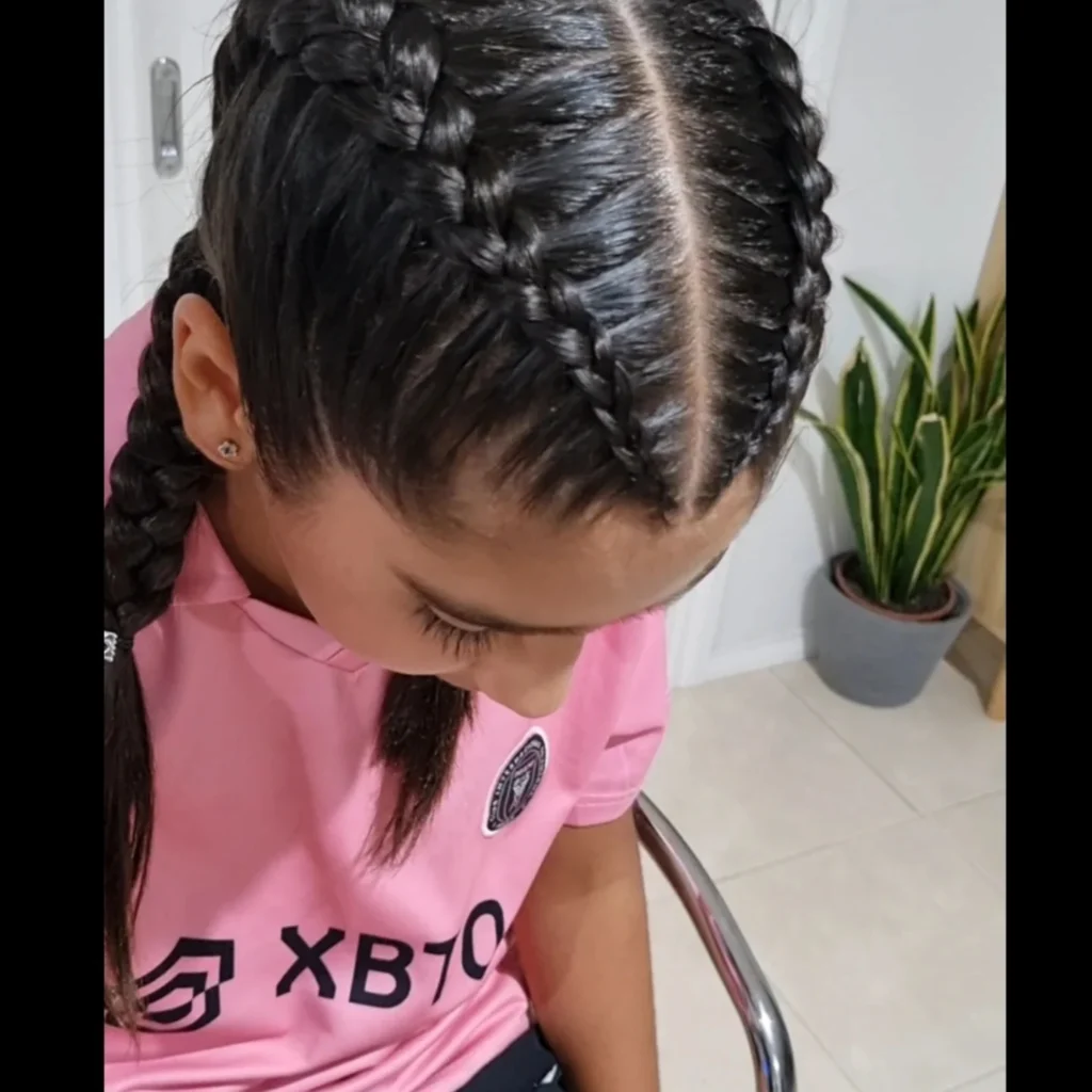 Neat stitch braids styled along a center part for a sporty look.