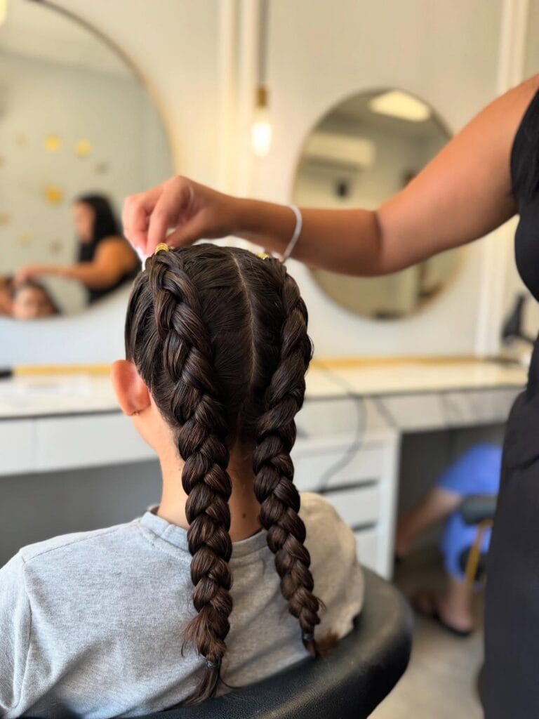 Two simple braids parted at the center and braided down the back.