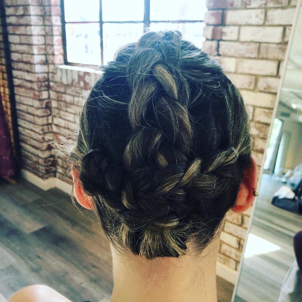 Thick braid wrapped into a low braided bun.