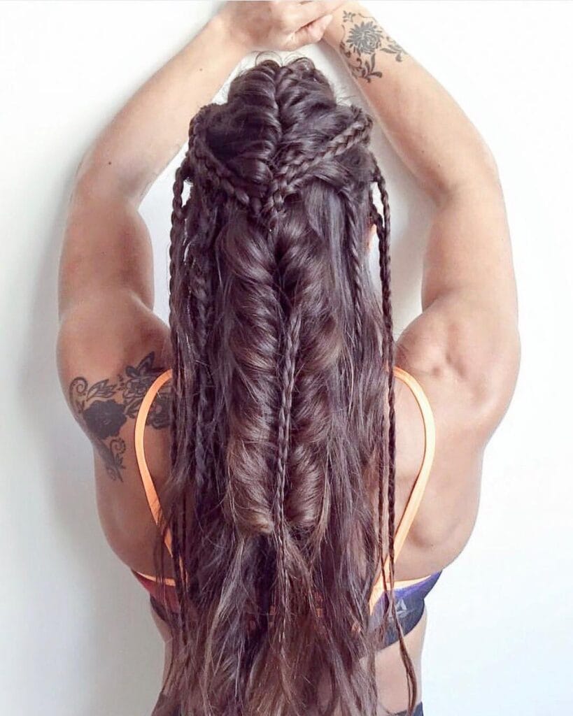 Multiple small braids gathered into a long braid down the back.
