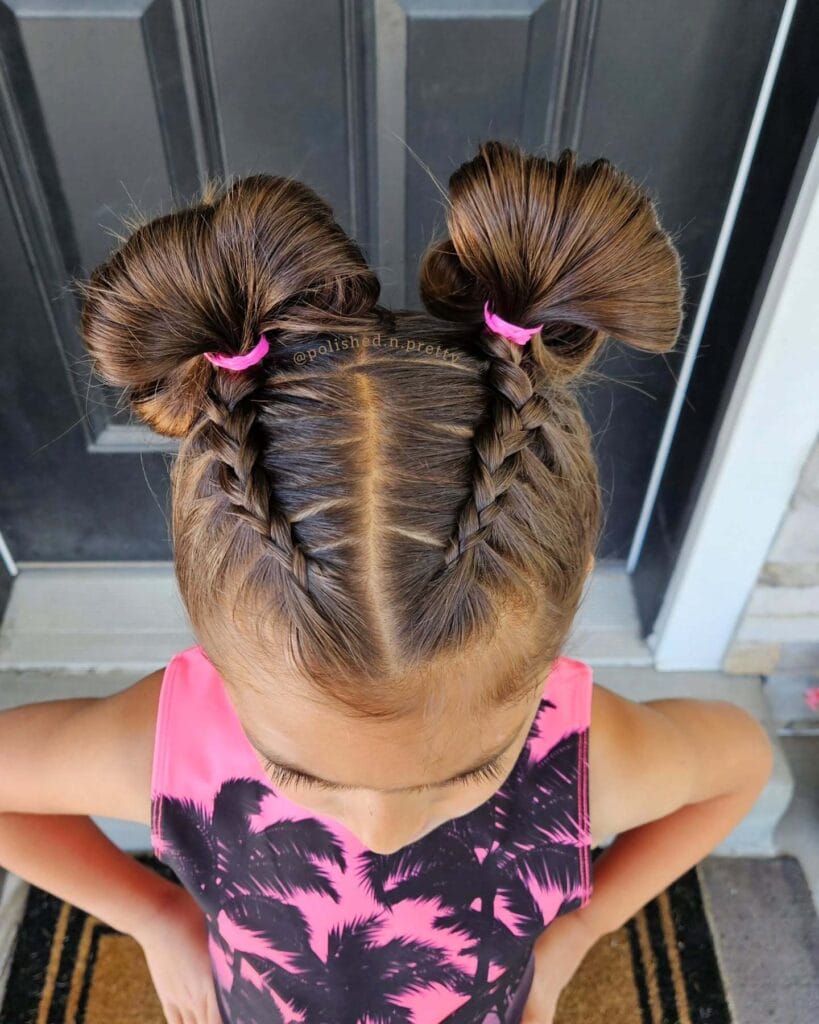 Two short braids parted at the center with soft ends.