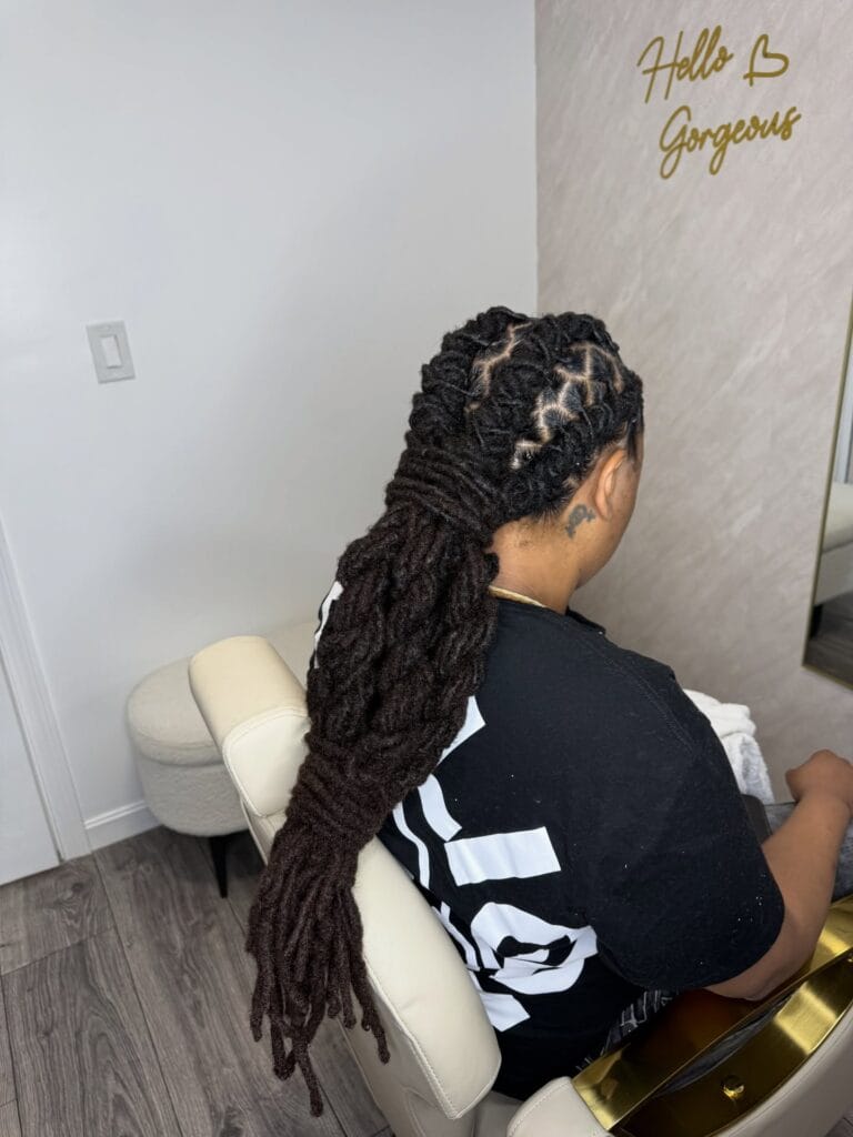 Neat cornrows braided toward the back into a long braided ponytail.