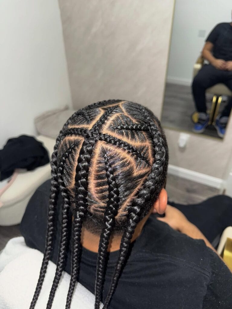 Geometric cornrow pattern braided into long hanging braids.