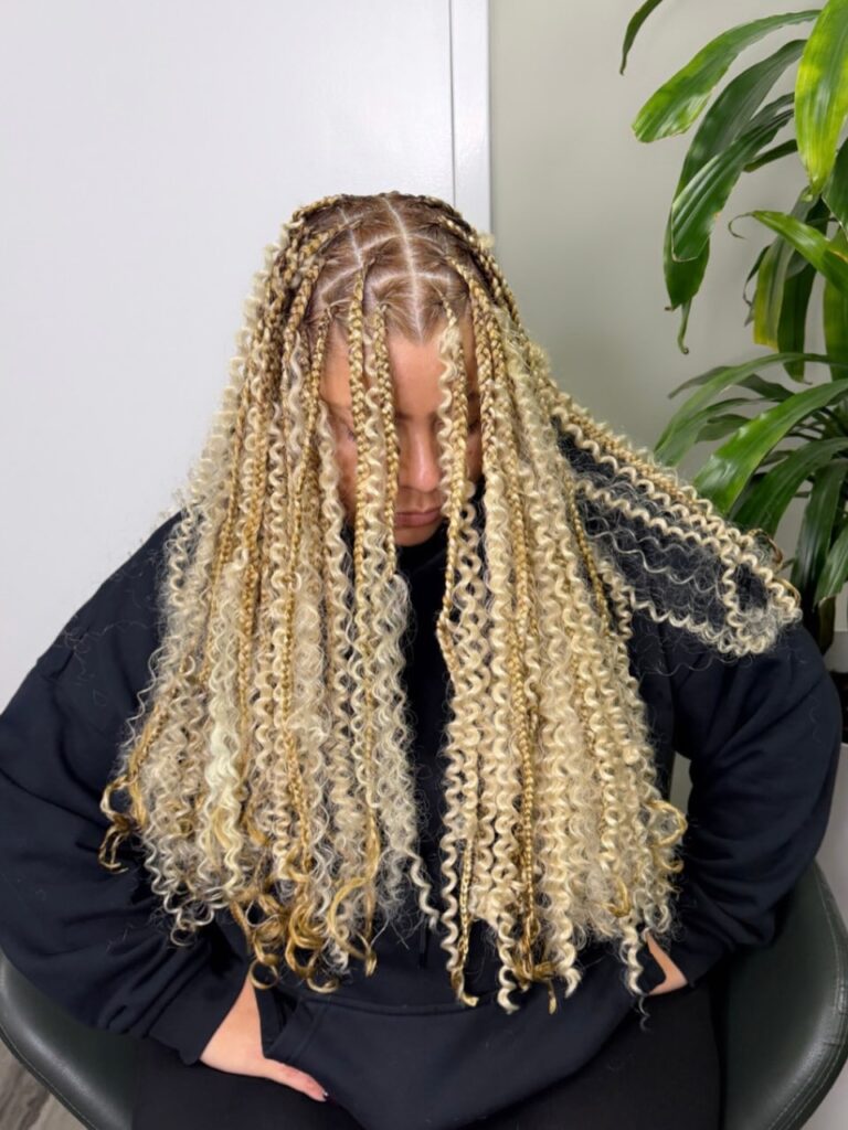 Blonde boho braids with tight spiral curls creating a full textured look.