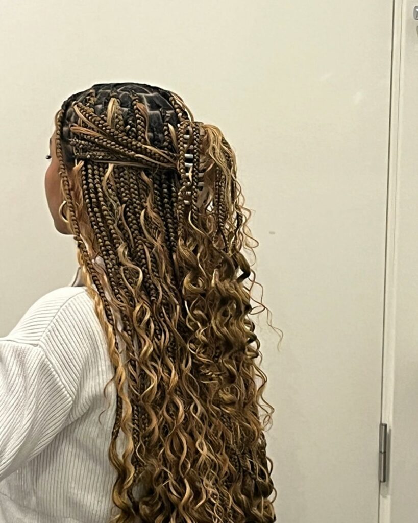 Brown and blonde boho braids with layered lengths and defined curly ends.